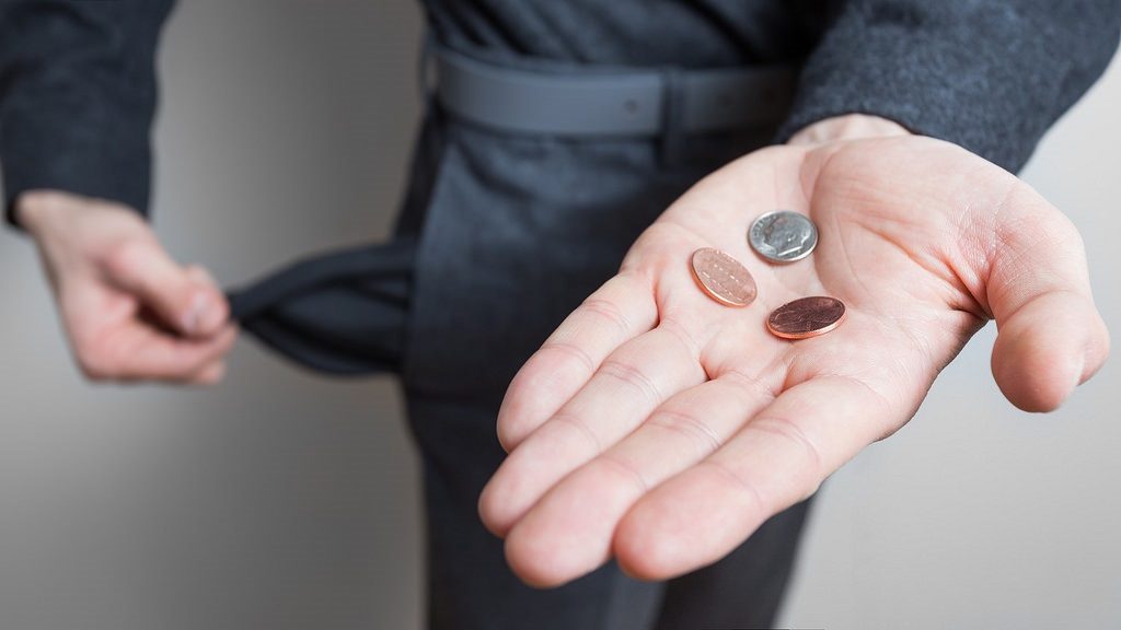 Man with change in his hand and empty pockets