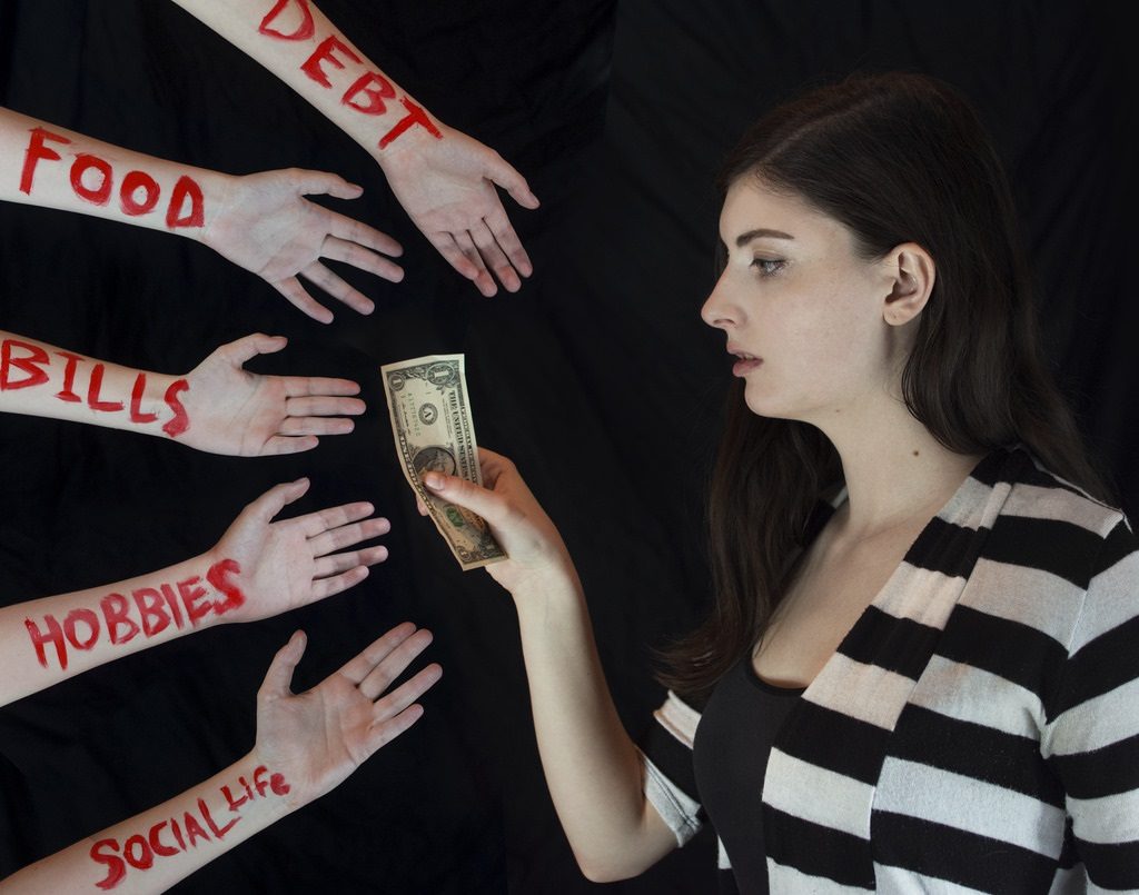 Woman handing money to different hands titles debit and bills