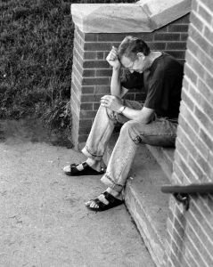 Frustrated man sitting on a stoop