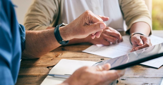 couple with a tablet for planning, mortgage payment or home budget