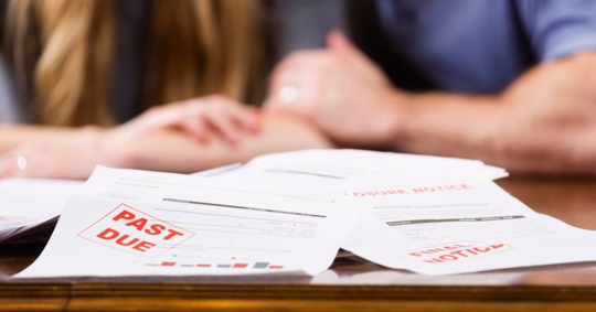 Foreclosure documents with couple in the background