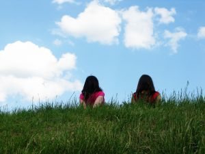 two girls in grass