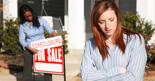 Sad Woman Outside Home While Real Estate Agent Puts up Foreclosure Sign