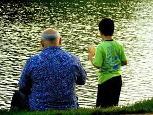 Grandparent and grandchild by a lake