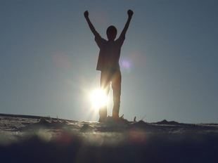 Person standing with arms in the air